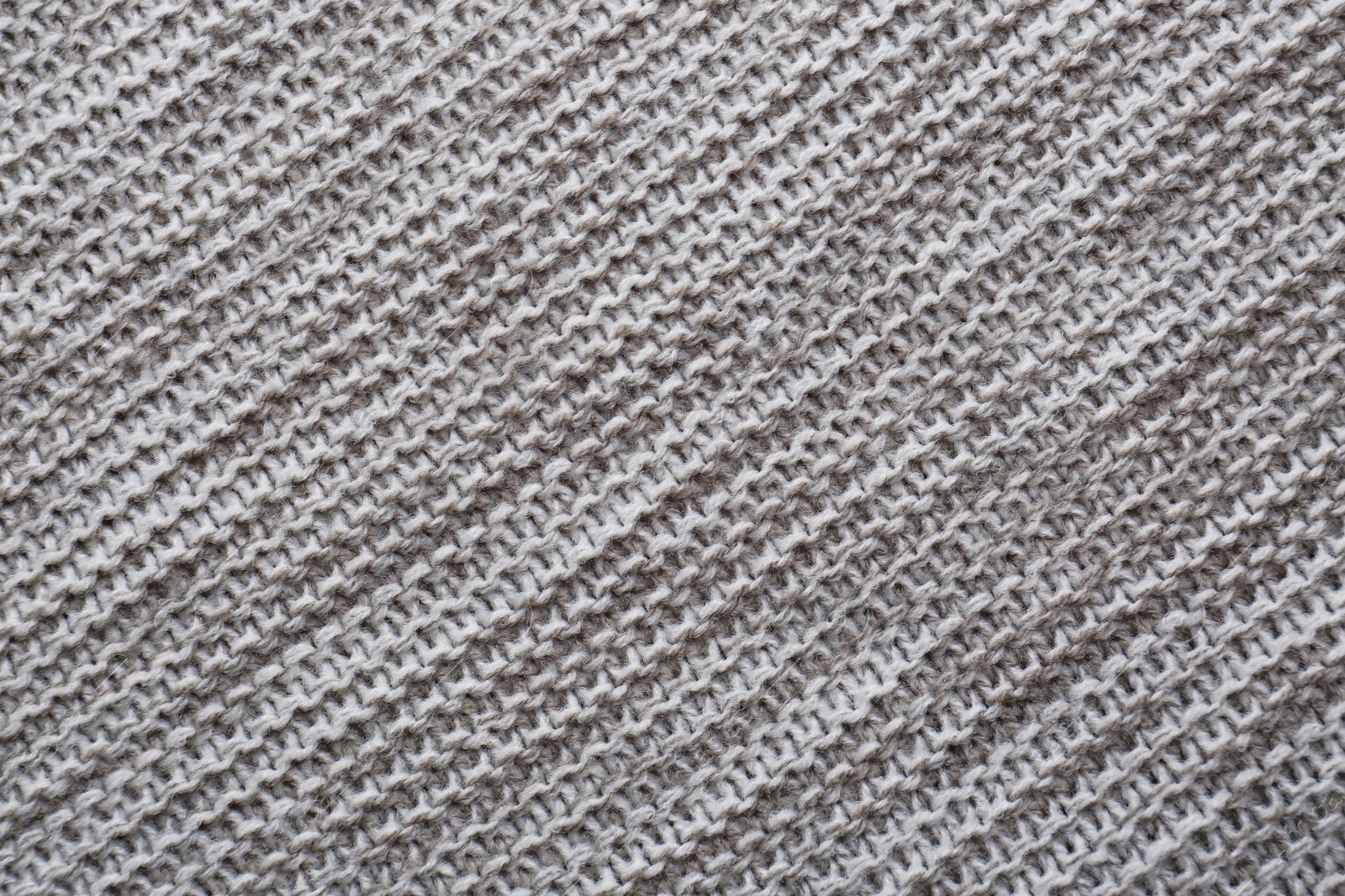 Photo of Beautiful grey knitted fabric as background, top view