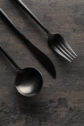 Stylish cutlery on grey table, flat lay