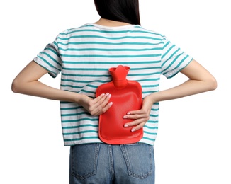 Woman using hot water bottle to relieve low back pain on white background, closeup