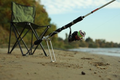 Photo of Fishing rod and folding chair at riverside