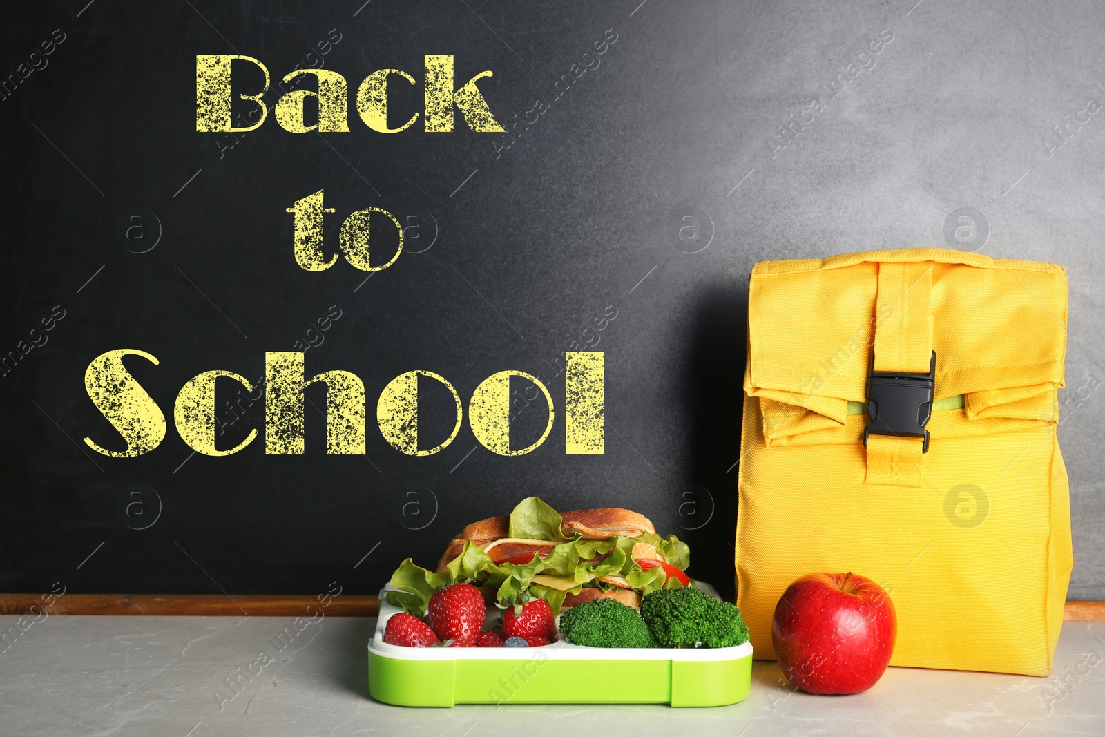 Image of Lunch for schoolchild on table near blackboard