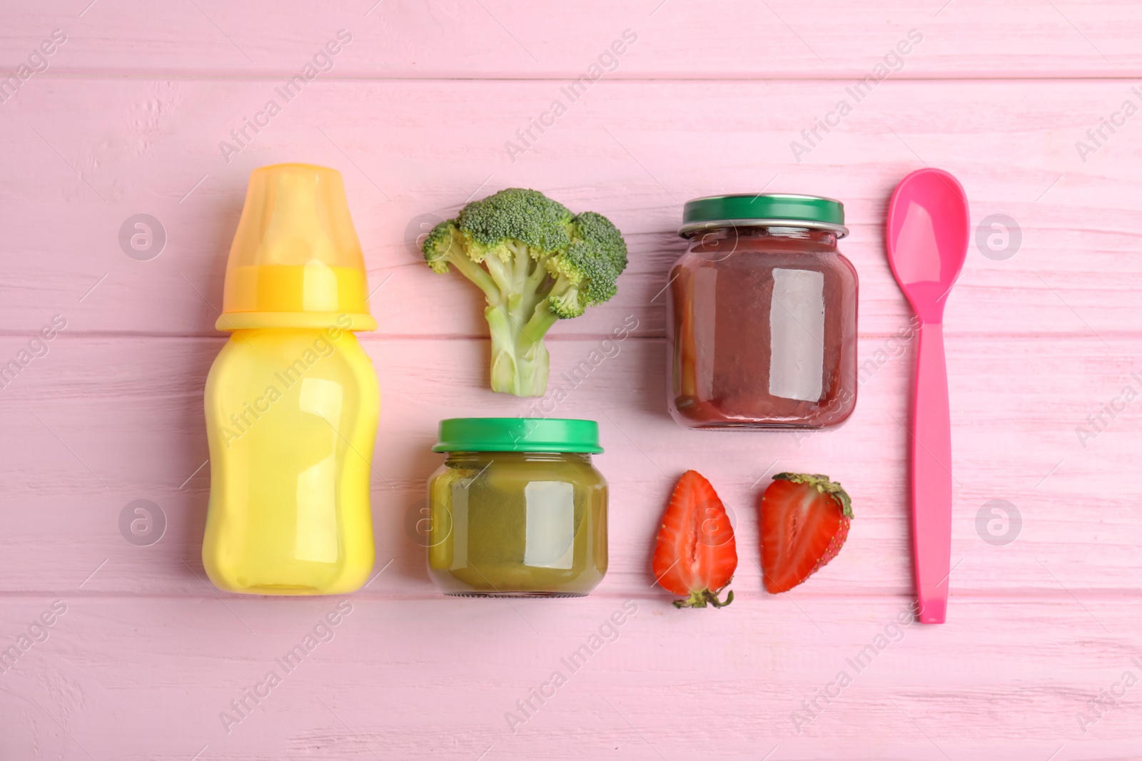 Photo of Flat lay composition with healthy baby food and ingredients on pink wooden table