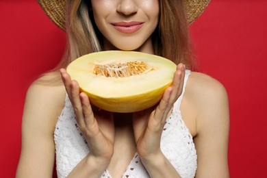 Young woman with fresh melon on red background, closeup. Exotic fruit