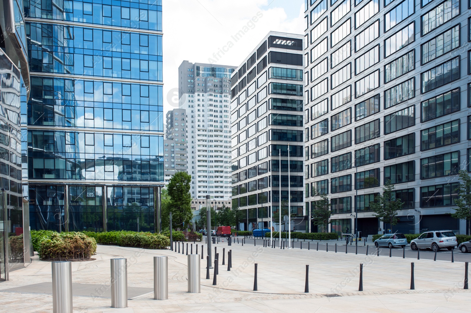 Photo of Bollards, cars and beautiful buildings in city