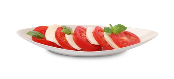 Photo of Plate of delicious Caprese salad with tomatoes, mozzarella and basil isolated on white