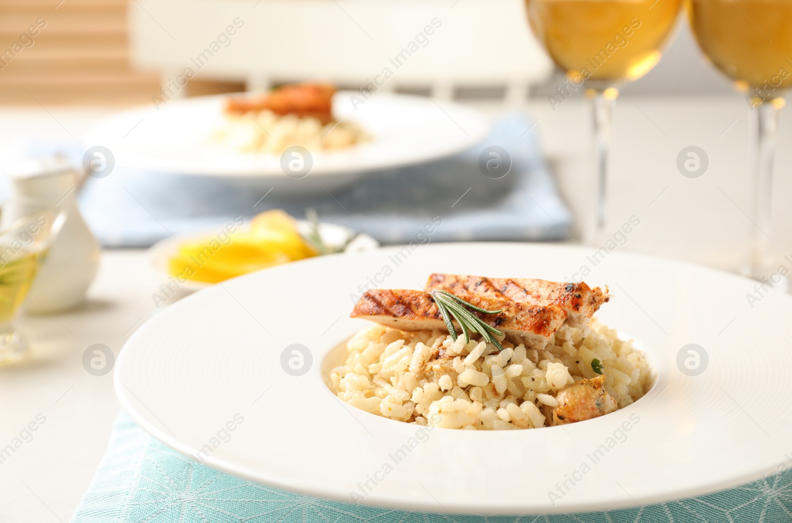 Photo of Delicious chicken risotto served on table, closeup