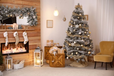 Photo of Festive interior with beautiful Christmas tree and gifts