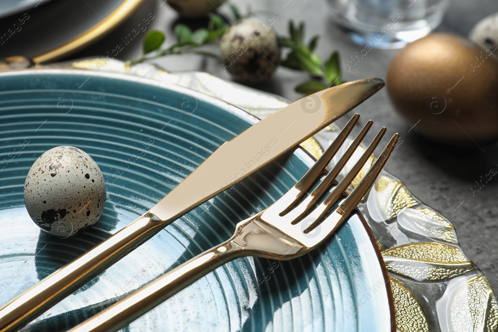 Photo of Festive Easter table setting with eggs on color background, closeup