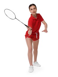 Young woman playing badminton with racket on white background