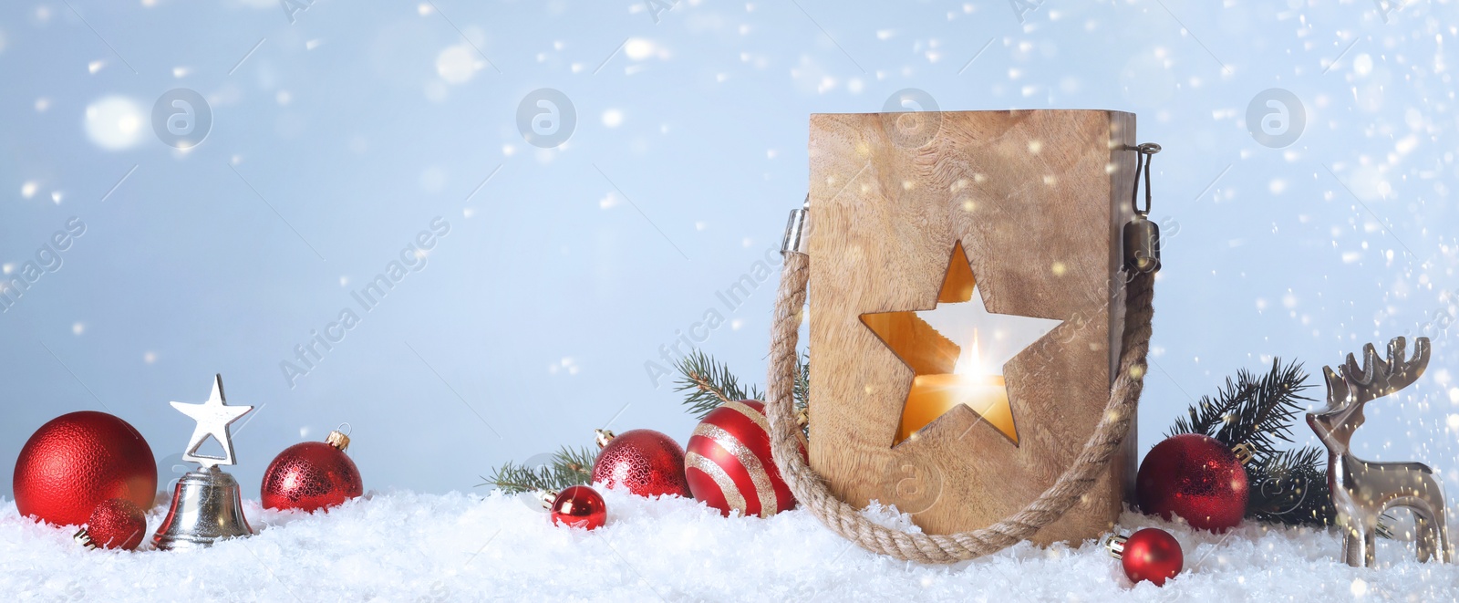 Image of Composition with wooden Christmas lantern on snow against light grey background. Banner design