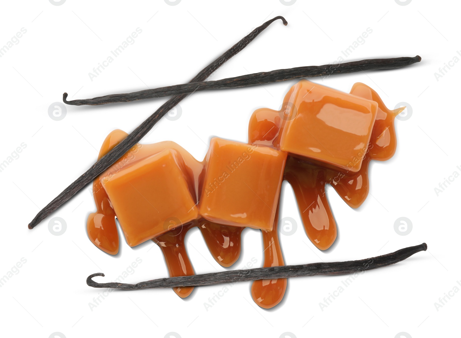 Image of Caramel candies and vanilla pods isolated on white, top view
