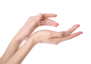 Photo of Young woman applying natural scrub on hands against white background