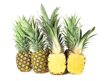 Whole and cut juicy pineapples isolated on white