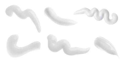 Image of Set with smears of toothpaste on white background