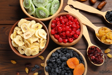Photo of Flat lay composition with different dried fruits on wooden background. Healthy lifestyle