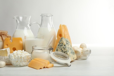 Different delicious dairy products on white table