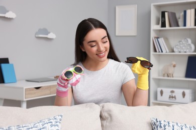 Happy woman performing puppet show at home