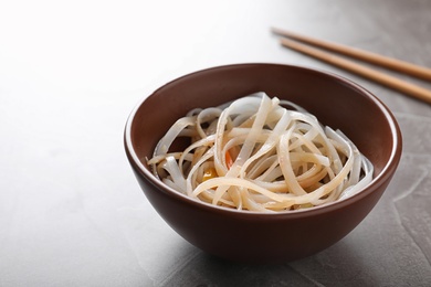 Photo of Bowl of delicious rice noodles on table
