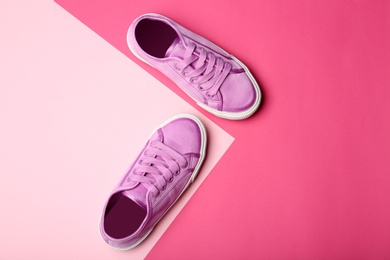 Photo of Stylish new shoes on color background, top view