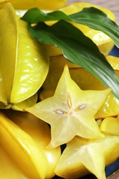 Photo of Pile of delicious fresh carambola fruits on table