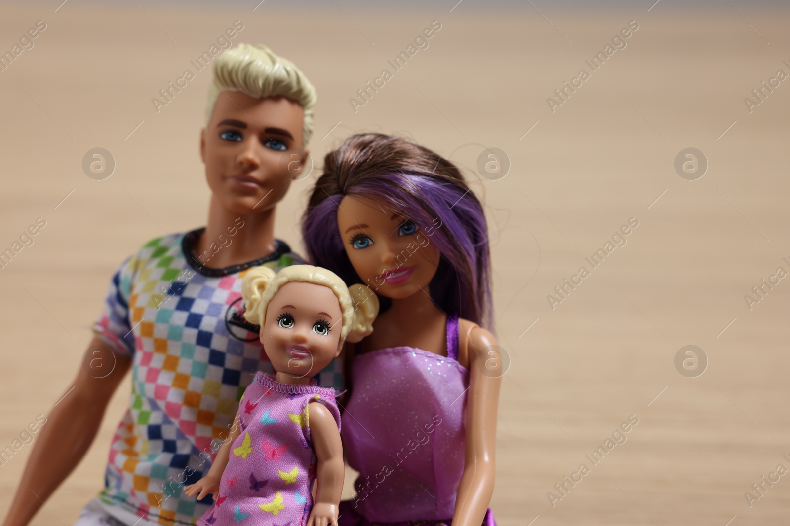 Photo of Leiden, Netherlands - September 20, 2023: Beautiful Barbie, Ken and Chelsea dolls on beige background, space for text