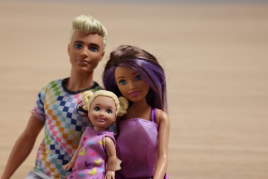 Leiden, Netherlands - September 20, 2023: Beautiful Barbie, Ken and Chelsea dolls on beige background, space for text