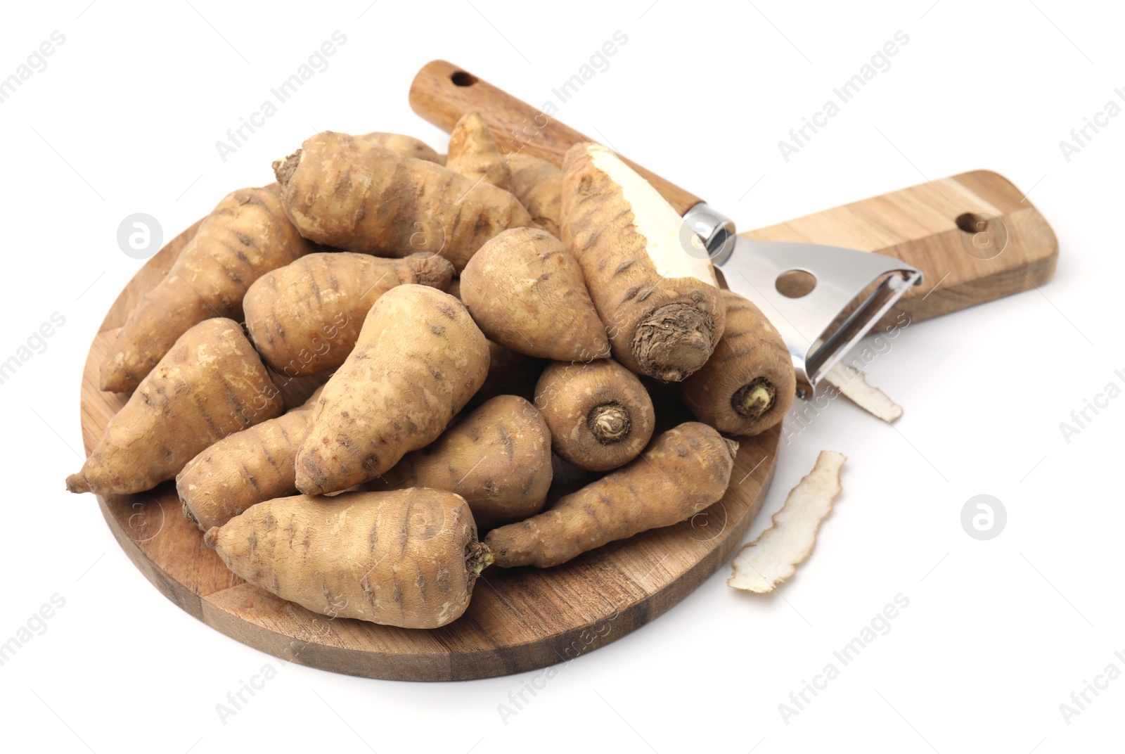 Photo of Tubers of turnip rooted chervil and peeler isolated on white