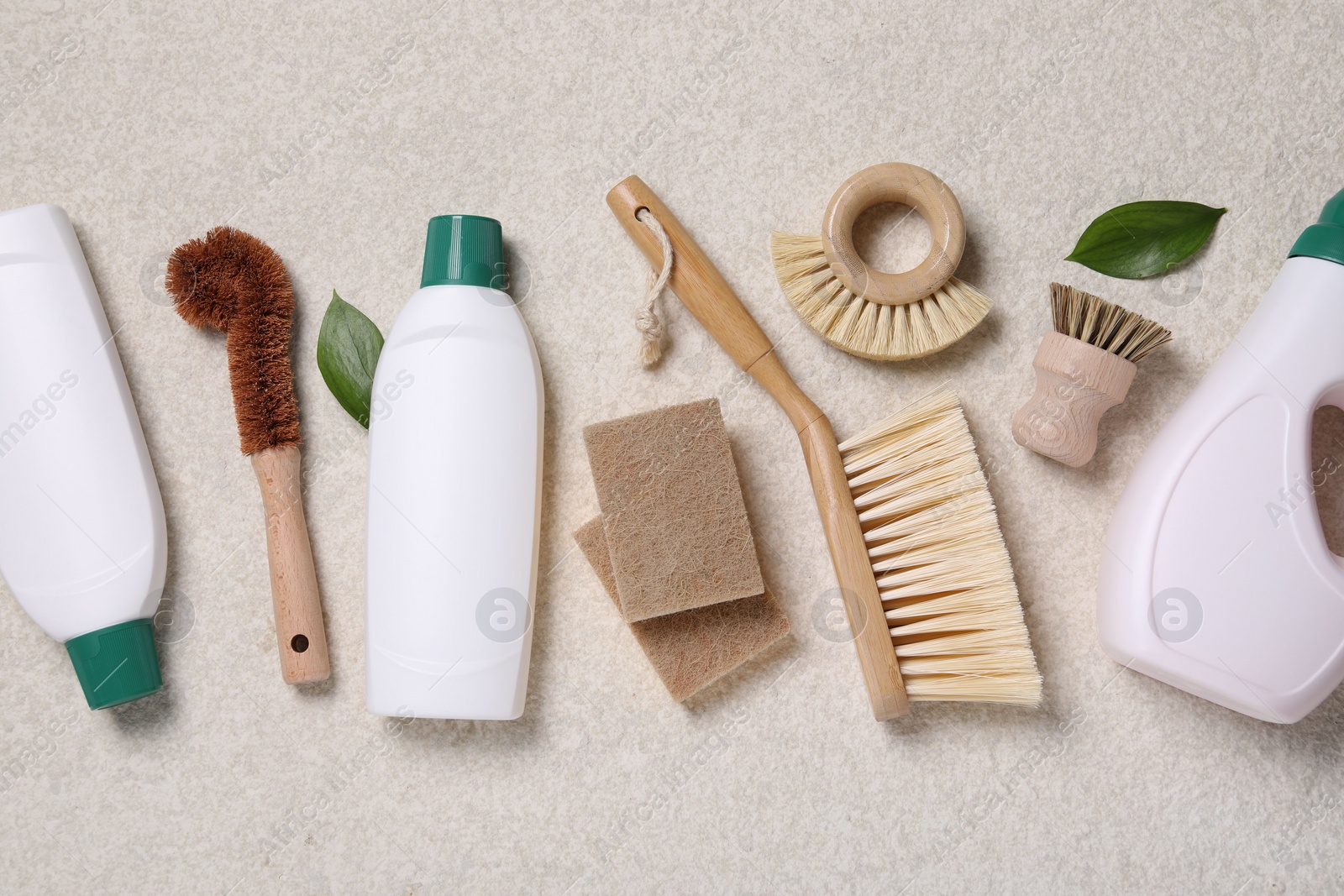 Photo of Flat lay composition with different cleaning supplies on beige background