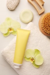 Photo of Flat lay composition with spa products and beautiful flowers on white marble table