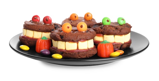 Photo of Delicious desserts decorated as monsters on white background. Halloween treat