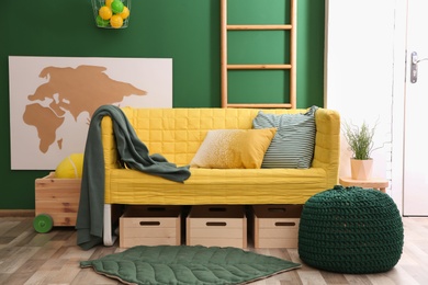 Modern room interior with sofa and wooden crates. Eco style