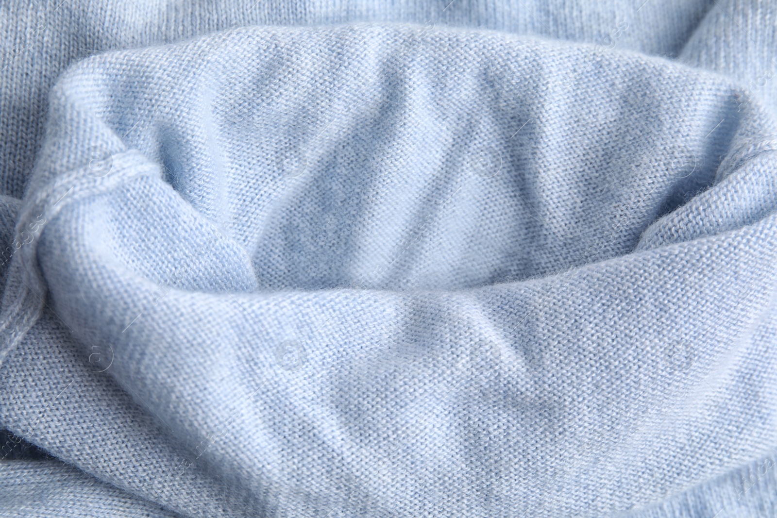 Photo of Warm light blue cashmere sweater as background, closeup