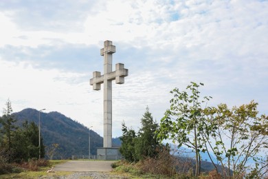 Photo of Beautiful view of big old cross and mountains