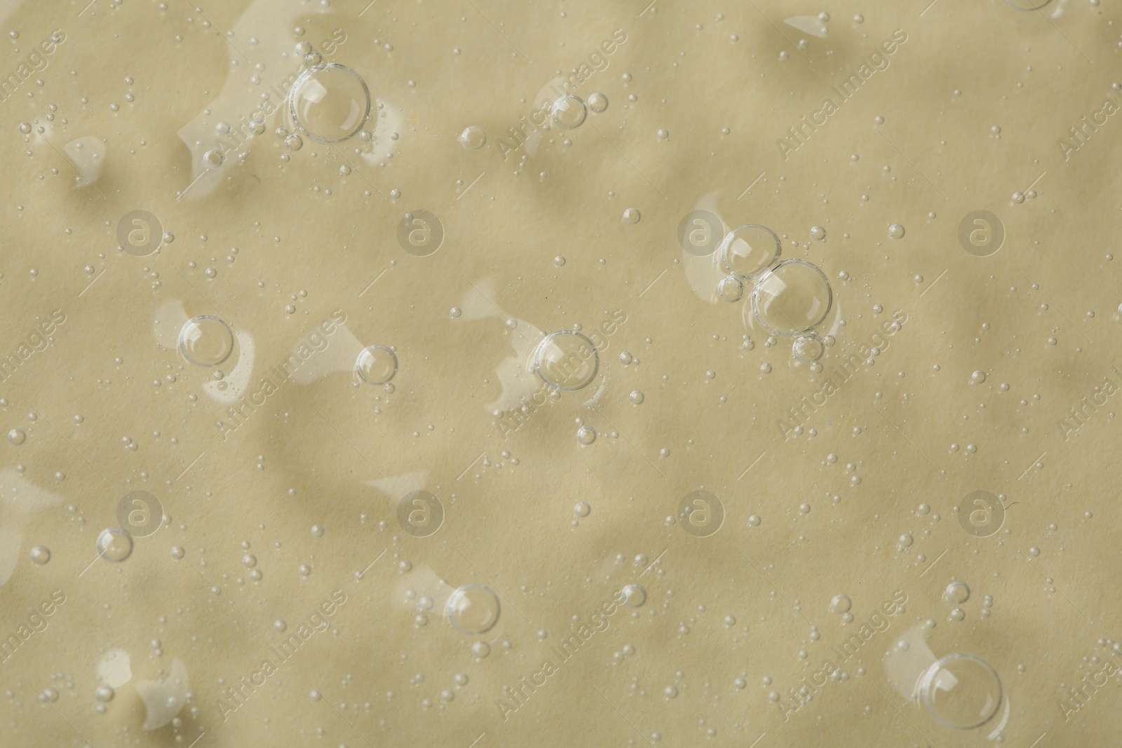 Photo of Cosmetic serum on beige background, top view