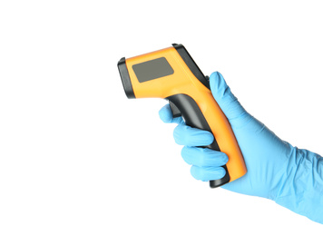 Doctor in latex gloves holding non-contact infrared thermometer on white background, closeup