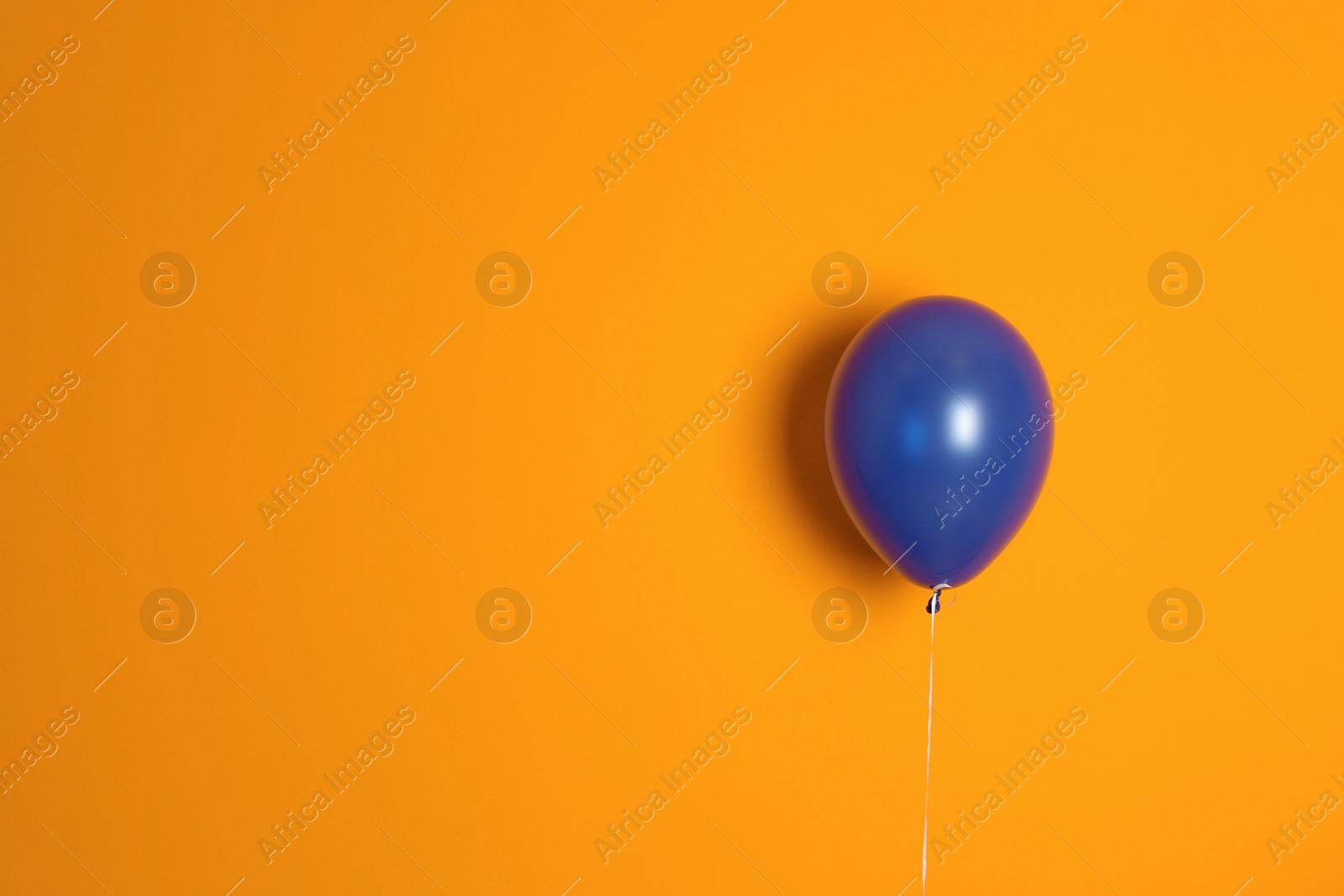 Photo of Purple balloon on color background. Celebration time