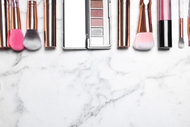 Photo of Different luxury makeup products on white marble table, flat lay. Space for text