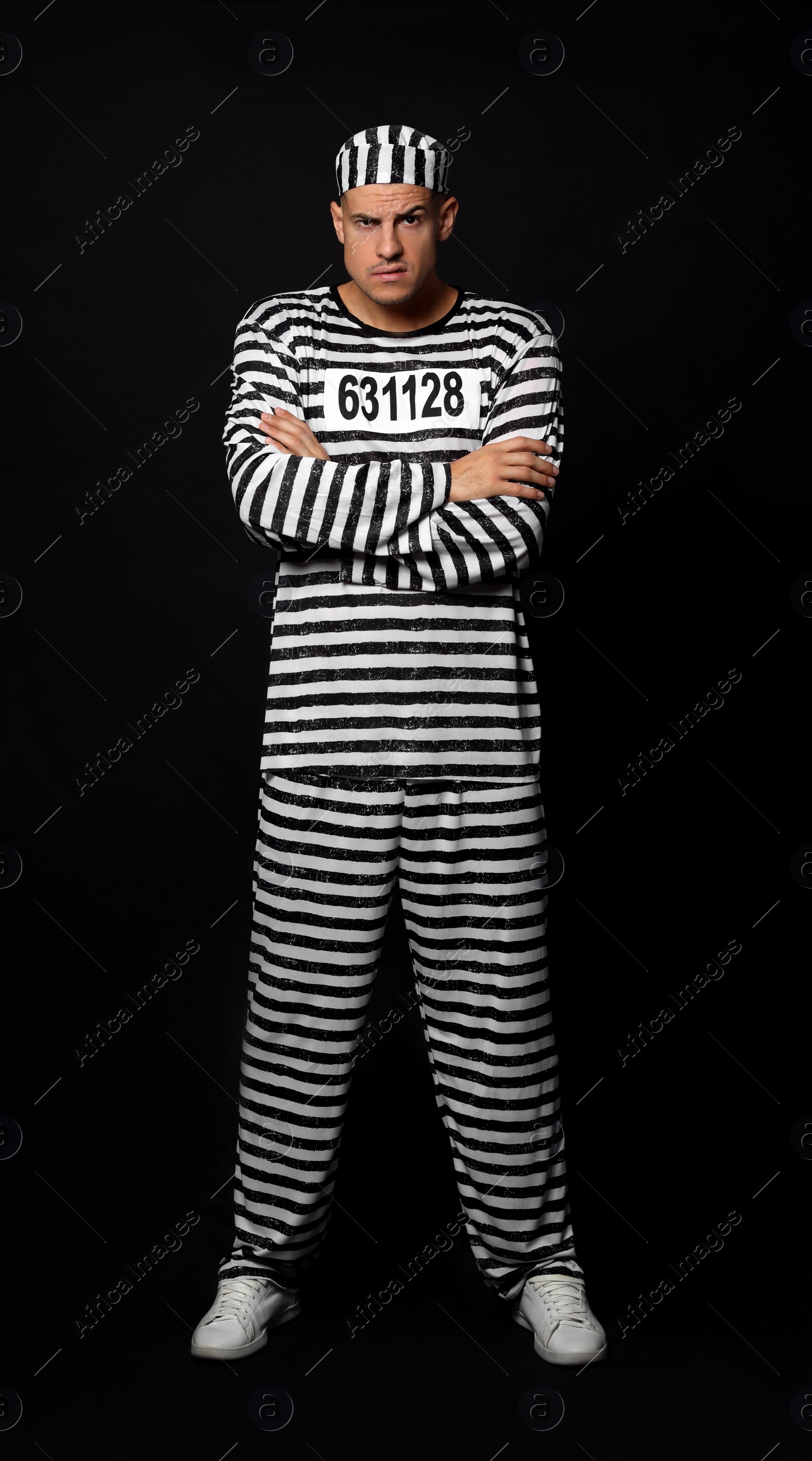 Photo of Prisoner in striped uniform on black background