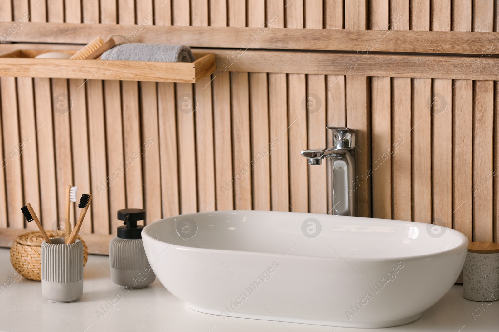 Photo of Stylish vessel sink near wooden wall in modern bathroom