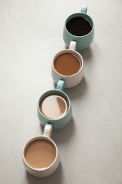 Cups of fresh aromatic coffee on gray background. Food photography