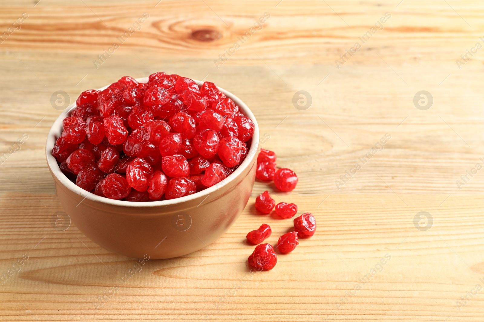 Photo of Bowl of sweet cherries on wooden background, space for text. Dried fruit as healthy snack