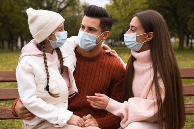 Photo of Lovely family spending time together in park during coronavirus pandemic