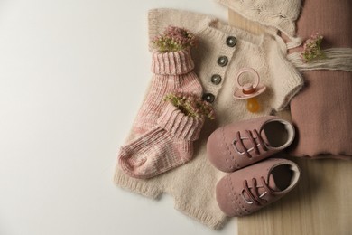 Baby clothes, shoes and accessories on light background, flat lay. Space for text