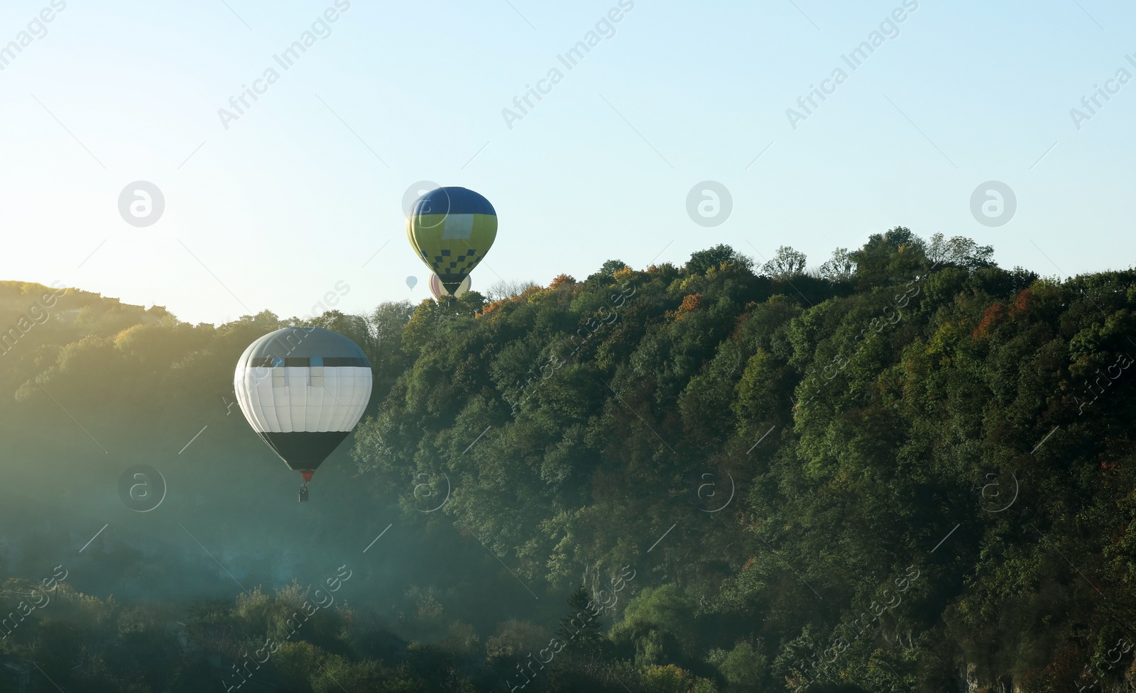 Photo of Beautiful view of hot air balloons flying over autumn forest