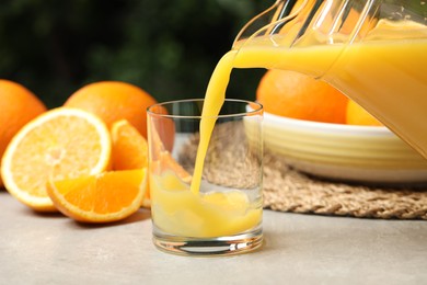 Photo of Pouring orange juice into glass at light table