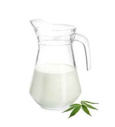 Pitcher of hemp milk and green leaves on white background
