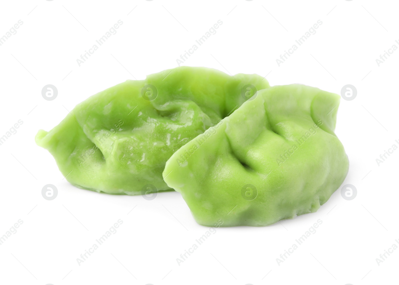 Photo of Two delicious green dumplings (gyozas) isolated on white