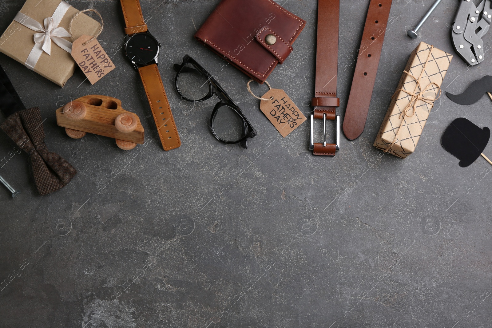 Photo of Flat lay composition male accessories on grey stone background, space for text. Happy Father's day