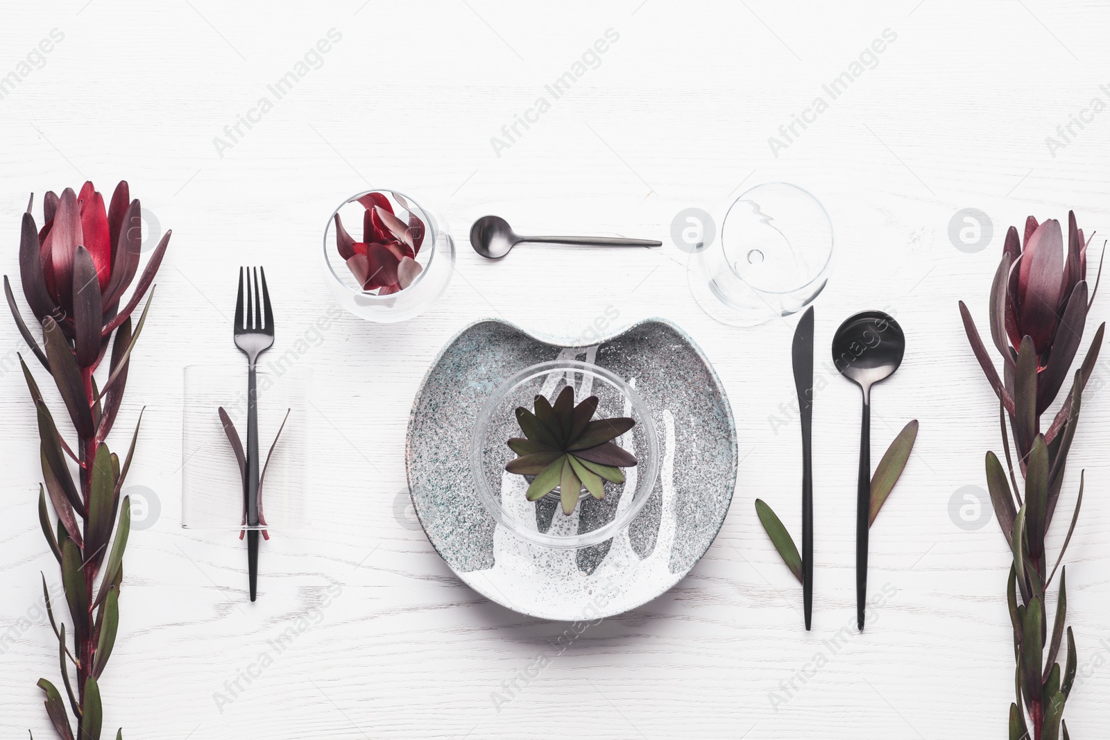 Photo of Elegant table setting with floral decor on white wooden background, flat lay