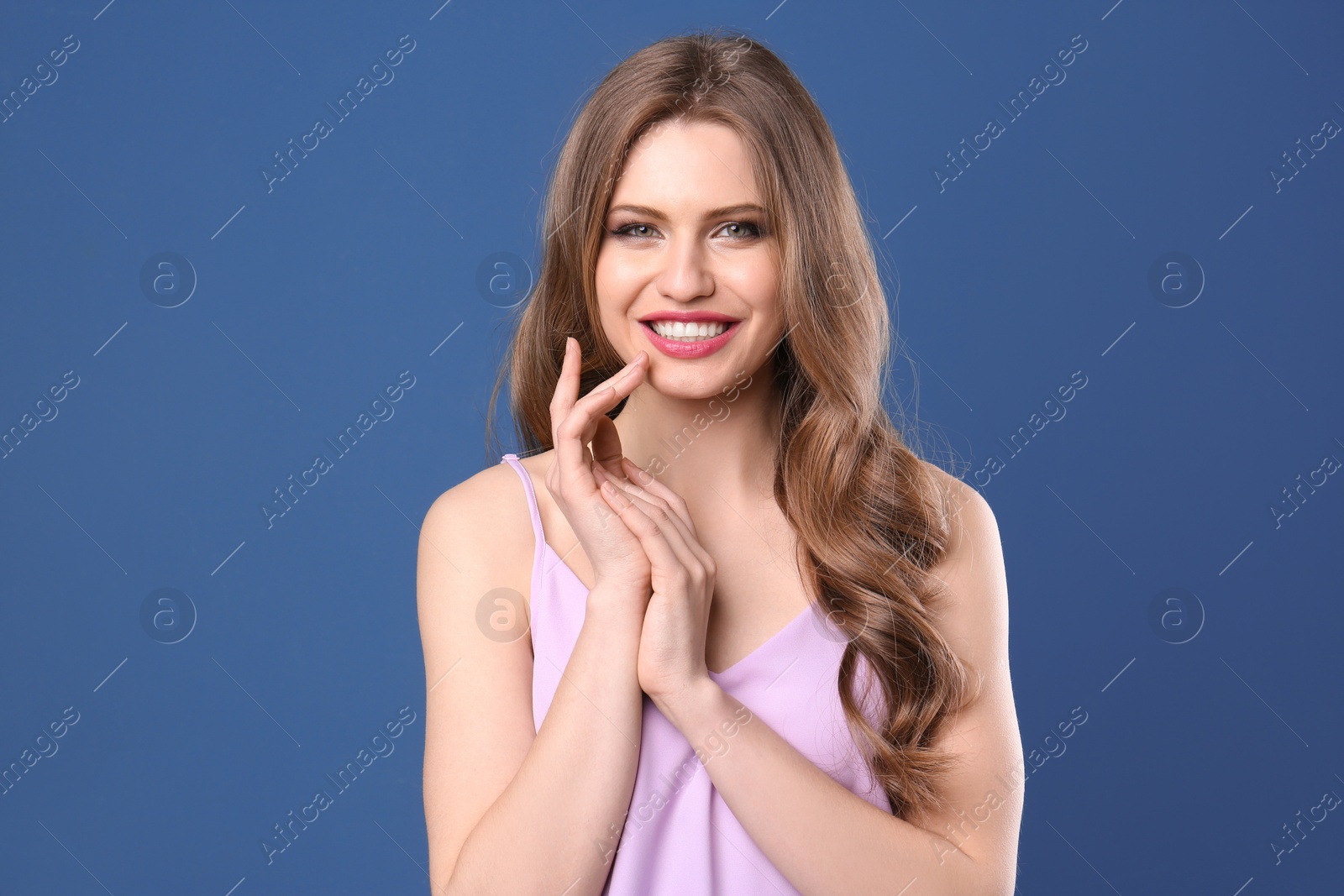 Photo of Portrait of young woman with long beautiful hair on color background